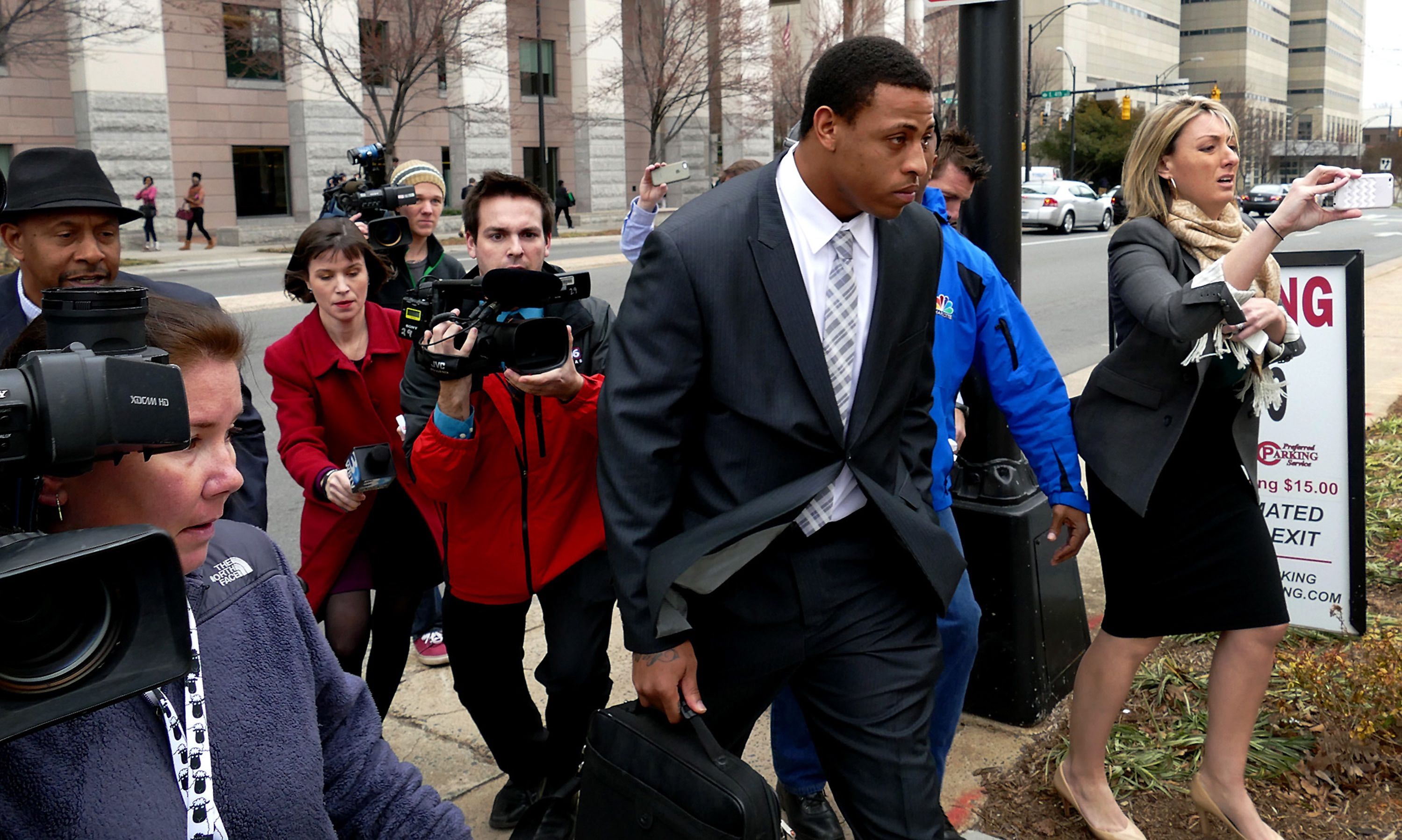 Carolina Panthers defensive end Greg Hardy leaves the Mecklenburg County Courthouse with the media seeking comment on Feb. 9, 2015 in Charlotte, N.C. Hardy&apos;s domestic-abuse case was abruptly dismissed Monday because his accuser is believed to have reached an undisclosed civil settlement with Hardy could not be found to testify. (Jeff Siner/Charlotte Observer/TNS)