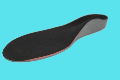 A custom foot orthotic with an aqua coloured background