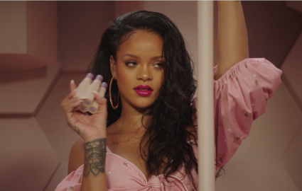 Rihanna poses with Fenty Beauty products.