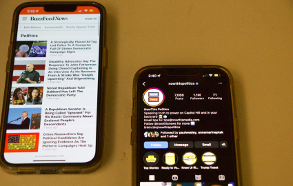 Two phones side by side with the accounts of news outlets open.