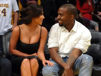 Creative Commons  Kim and Kanye share a romantic moment at a basketball game. 