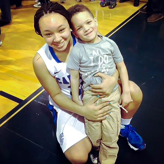 Sophmore guard Tayler Holmes celebrates win with her five year old son.