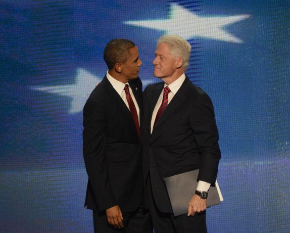 Obama and Clinton embracing