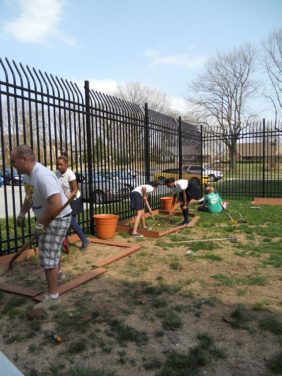 Cabrini students building raised beds with Stewart Middle School students. (Jen Cannon/Asst. Lifestyles Editor)