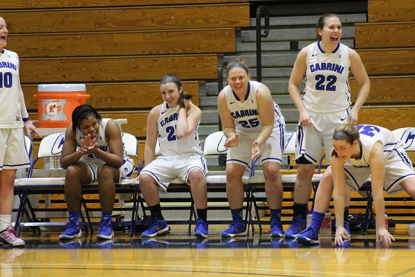 Players on the bench get excited over the team's play. ANGELINA MILLER / PHOTO FOR PUB