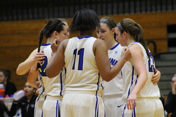 Cabrini's starting five huddle on the court. ANGELINA MILLER / PHOTO FOR PUB