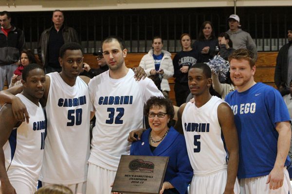 Cabrini seniors (left to right) Jeremy Knowles, DeLeon Floyd, Goran Dulac, A.J. Williams and John Glenn accept the CSAC championship plaque after defeating Keystone in the title game on Friday, Feb. 22. (Jaime Viggiano / Staff Photographer)