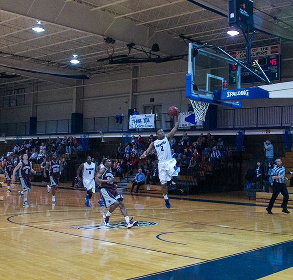 Sophomore Aaron Walton-Moss (No. 2) scores two of his 12 points on a lay-up in the Cavaliers’ 96-66 win over Rosemont College on Saturday, Feb. 9. (Dan Luner / Staff Photographer)