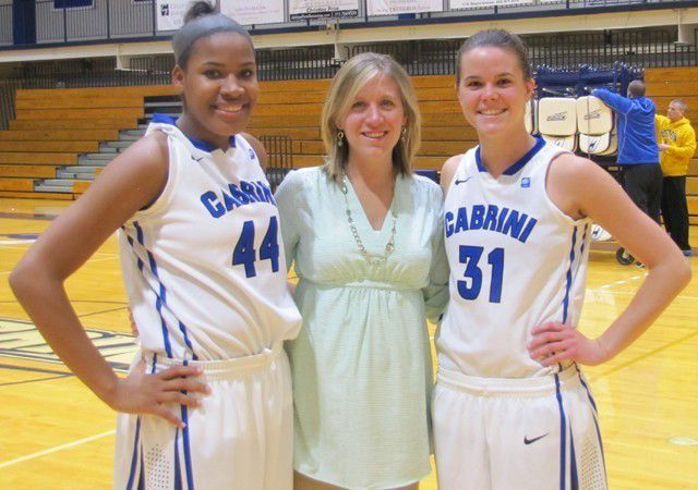 Amber Keys (left) and Megan Decker (right) celebrate their accomplishments with head coach Kate Pearson (middle).