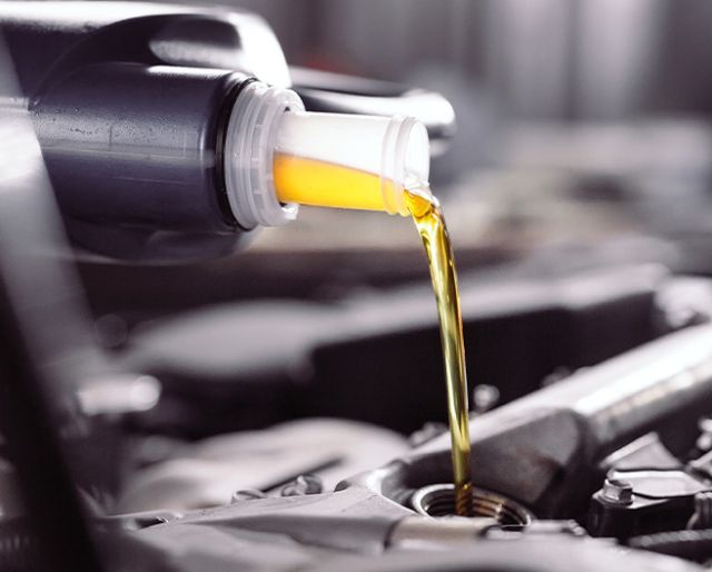 Difference between synthetic oil & conventional oil at Palmiero Toyota | Synthetic oil being poured in car engine 
