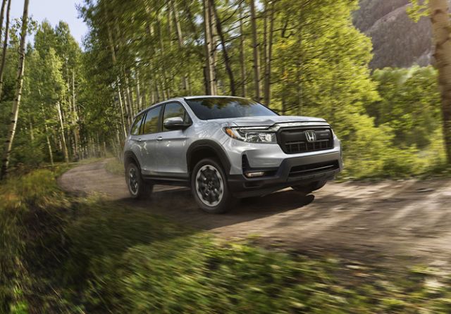 New 2025 Honda Passport at Delaney Honda | 2025 Honda Passport driving off road in the middle of a trail during the day