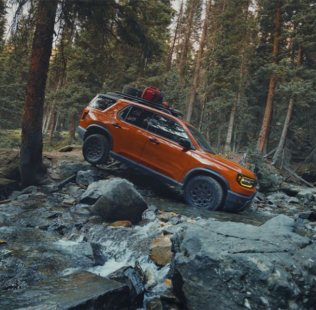 New 2026 Honda Passport at Delaney Honda | Side profile of a 2026 Honda Passport driving down a river
