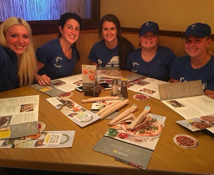 Women's rowing team enjoying dinner the night before a race. Photo from @cabrini_wrow on Instagram. 