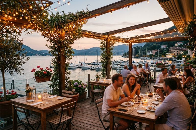 The Harbourside patio at dusk with string lights and a view of the marina