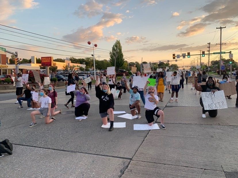People kneel in the streets, holding signs to protest against racism and police brutality.  The protest took place in King of Prussia
Photo by Chardanay White
