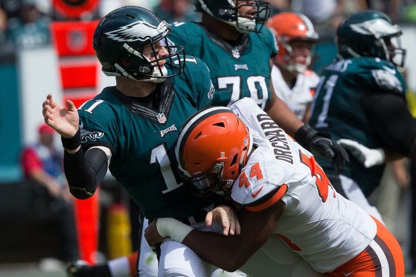 Sep 11, 2016; Philadelphia, PA, USA; Philadelphia Eagles quarterback Carson Wentz (11) is tackled by Cleveland Browns linebacker Nate Orchard (44) after throwing the ball during the second quarter at Lincoln Financial Field. Mandatory Credit: Bill Streicher-USA TODAY Sports